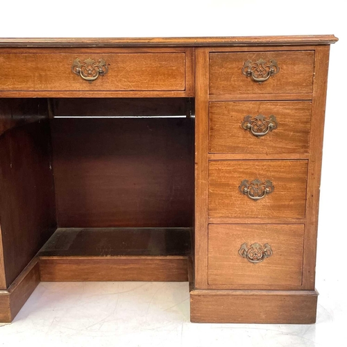 1890 - An Edwardian walnut kneehole desk. With tooled green leather skiver above one long and eight short d... 