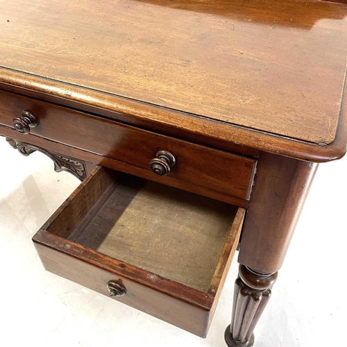 1891 - A William IV mahogany side table. With a raised back and fitted with four drawers on turned and flut... 