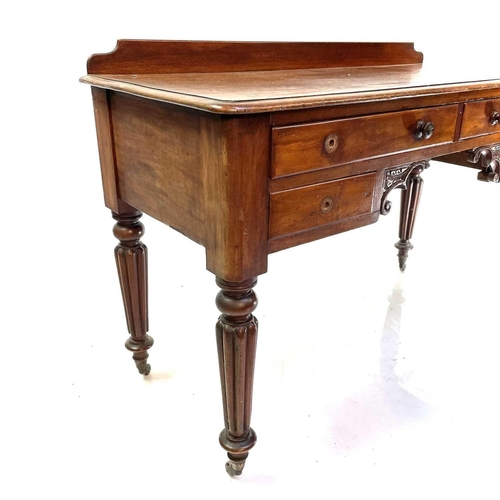 1891 - A William IV mahogany side table. With a raised back and fitted with four drawers on turned and flut... 