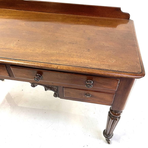 1891 - A William IV mahogany side table. With a raised back and fitted with four drawers on turned and flut... 