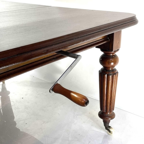 1894 - A Victorian mahogany extending dining table. With wind-out mechanism and fitted with two additional ... 