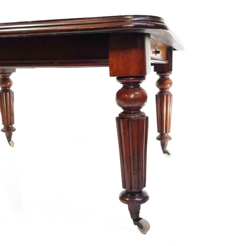 1894 - A Victorian mahogany extending dining table. With wind-out mechanism and fitted with two additional ... 