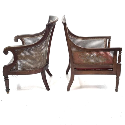 1895 - A late George III mahogany Bergere armchair. With caned seat, back and sides on turned and reeded le... 