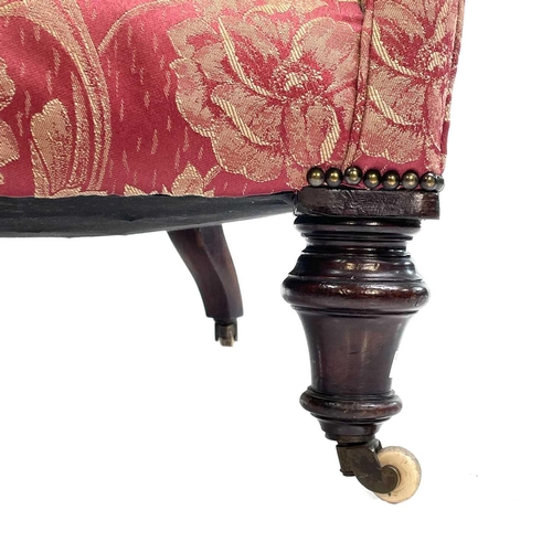 1897 - A mid-Victorian walnut framed button back armchair. With rose brocade upholstery on turned front leg... 