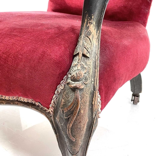 1900 - A Victorian walnut framed spoon back armchair. With buttoned upholstery and raised on carved cabriol... 