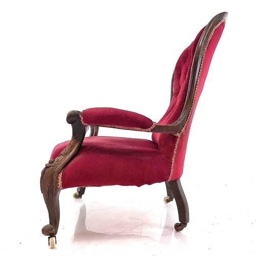 1900 - A Victorian walnut framed spoon back armchair. With buttoned upholstery and raised on carved cabriol... 