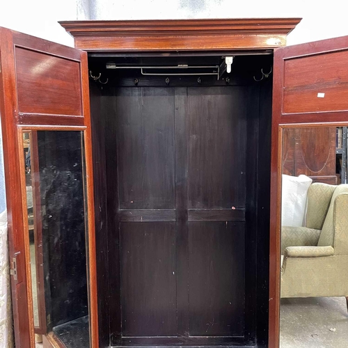 1902 - A late Victorian mahogany and satinwood banded wardrobe. With two panel doors on a plinth base, heig... 