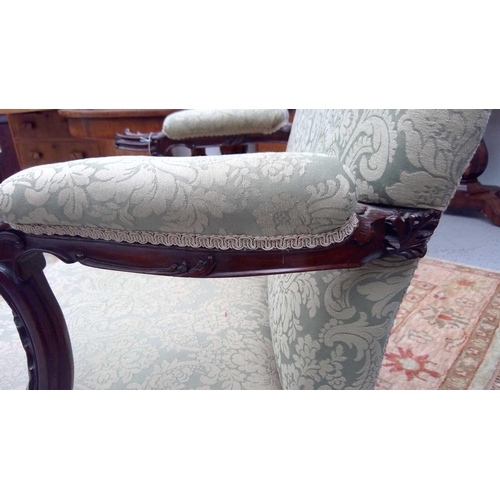 1903 - A George III mahogany Gainsborough type open armchair. The padded arms with prominent moulded outswe... 