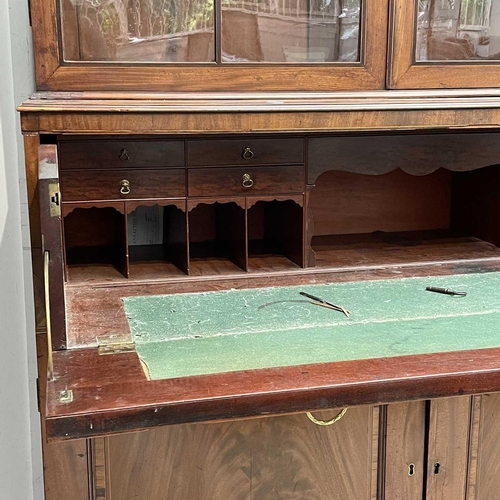 1904 - A George III mahogany and satinwood banded secretaire bookcase. With an arcaded frieze, above two ar... 