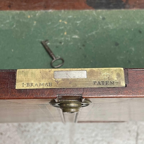 1904 - A George III mahogany and satinwood banded secretaire bookcase. With an arcaded frieze, above two ar... 