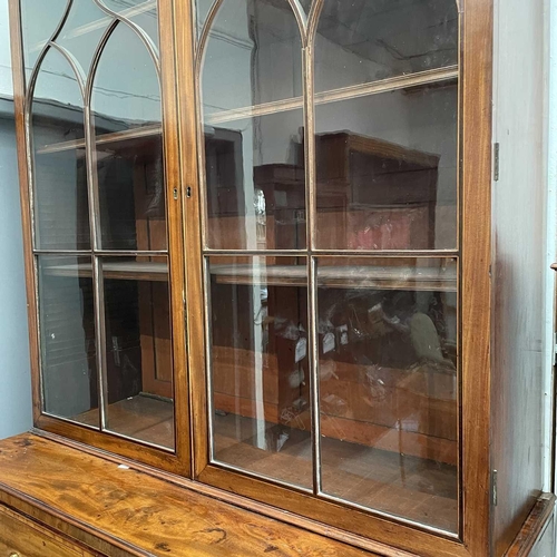 1904 - A George III mahogany and satinwood banded secretaire bookcase. With an arcaded frieze, above two ar... 