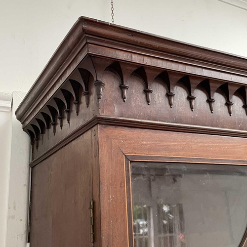 1904 - A George III mahogany and satinwood banded secretaire bookcase. With an arcaded frieze, above two ar... 