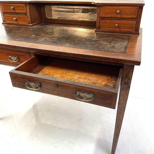 1907 - An early Victorian rosewood and line inlaid writing desk. The shaped superstructure with four drawer... 