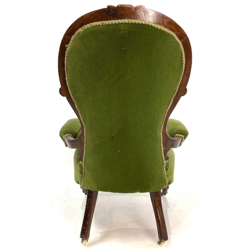 1910 - A Victorian walnut framed spoon back armchair. With button back and raised on carved cabriole legs, ... 