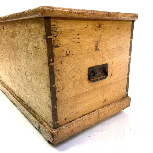 1911 - A Victorian pine trunk. Fitted with a candle box, height 50cm, width 95cm, depth 48cm.