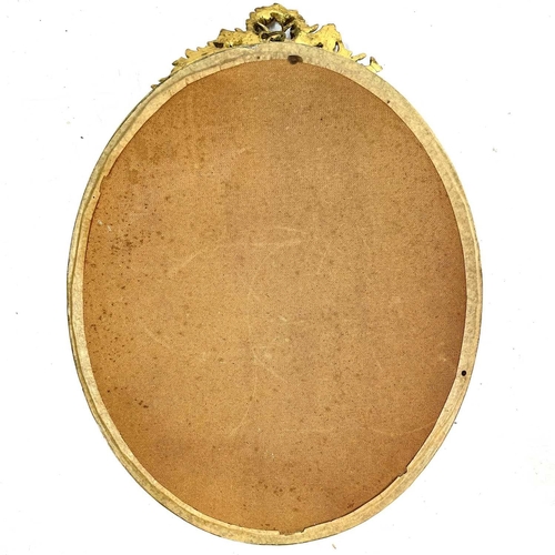 1914 - An Edwardian oval gilt wall mirror. With an ornate foliate gesso cresting and a bevel edge plate, 64... 