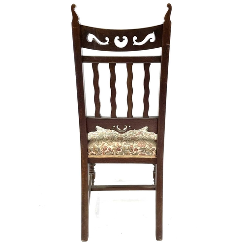 1916 - A set of four Arts and Crafts design oak dining chairs. With wavy slat backs, sprung seats and on ba... 