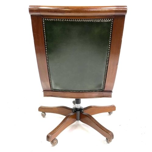 1919 - A mahogany and green leather upholstered swivel office chair. Raised on five outsplay supports and c... 