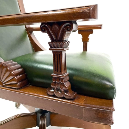 1919 - A mahogany and green leather upholstered swivel office chair. Raised on five outsplay supports and c... 