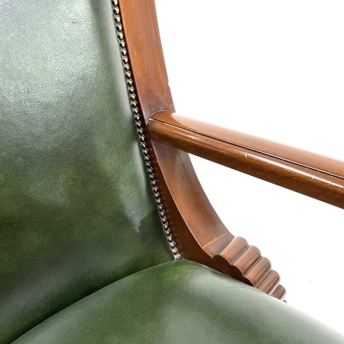 1919 - A mahogany and green leather upholstered swivel office chair. Raised on five outsplay supports and c... 