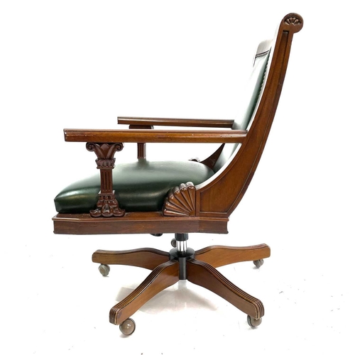 1919 - A mahogany and green leather upholstered swivel office chair. Raised on five outsplay supports and c... 