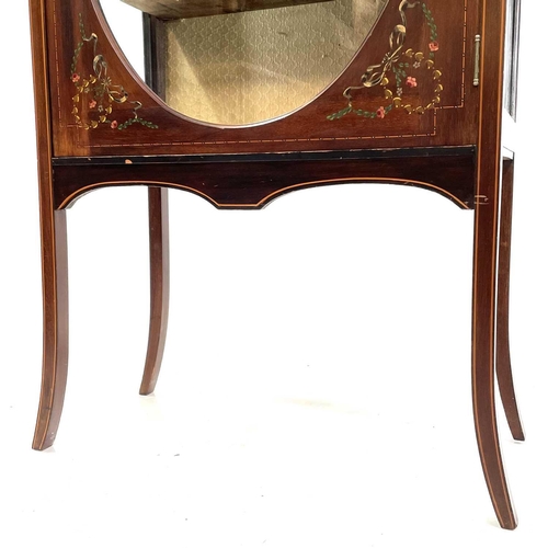 1920 - An Edwardian mahogany inlaid and painted display cabinet. With an oval glazed door enclosing three s... 