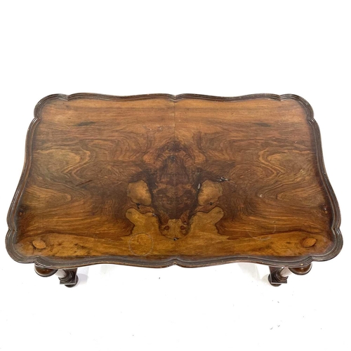 1924 - A walnut coffee table. With removable tray top and raised on turned legs and flattened stretchers, h... 