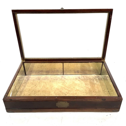 1928 - A mahogany and brass bound tabletop display cabinet. Mid 20th century, with slope top and mirrored i... 