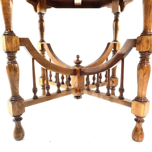 1930 - An Arts and Crafts walnut octagonal occasional table. With cross stretcher and turned spindle suppor... 