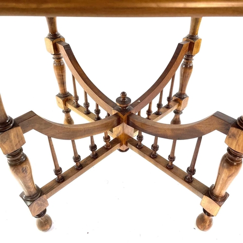 1930 - An Arts and Crafts walnut octagonal occasional table. With cross stretcher and turned spindle suppor... 