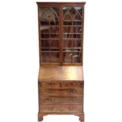 1937 - A Georgian bureau bookcase. With glazed upper section the lower section with writing fall revealing ... 