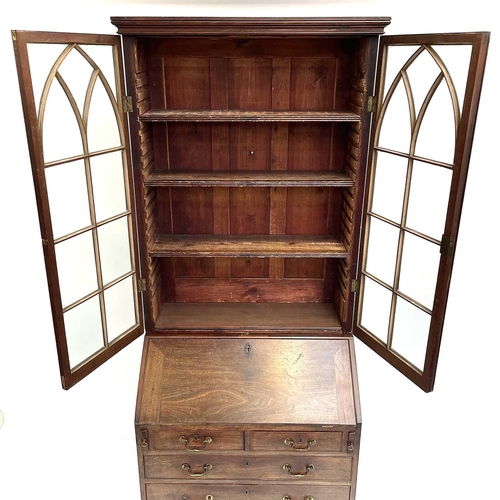 1937 - A Georgian bureau bookcase. With glazed upper section the lower section with writing fall revealing ... 