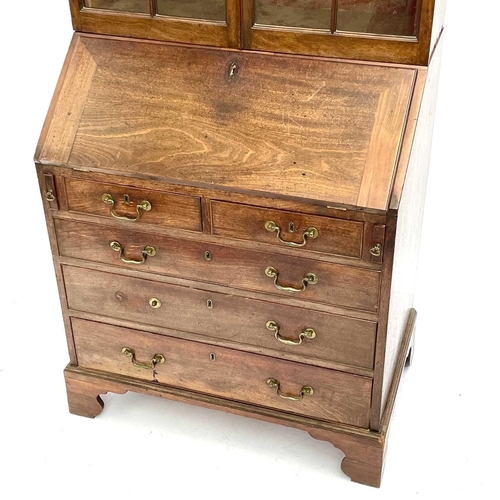 1937 - A Georgian bureau bookcase. With glazed upper section the lower section with writing fall revealing ... 