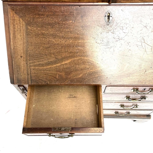 1937 - A Georgian bureau bookcase. With glazed upper section the lower section with writing fall revealing ... 