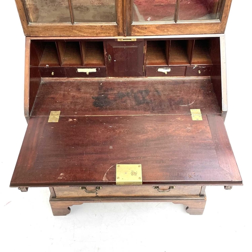 1937 - A Georgian bureau bookcase. With glazed upper section the lower section with writing fall revealing ... 