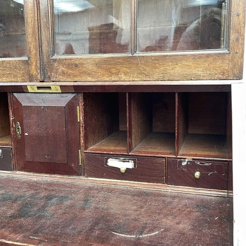 1937 - A Georgian bureau bookcase. With glazed upper section the lower section with writing fall revealing ... 