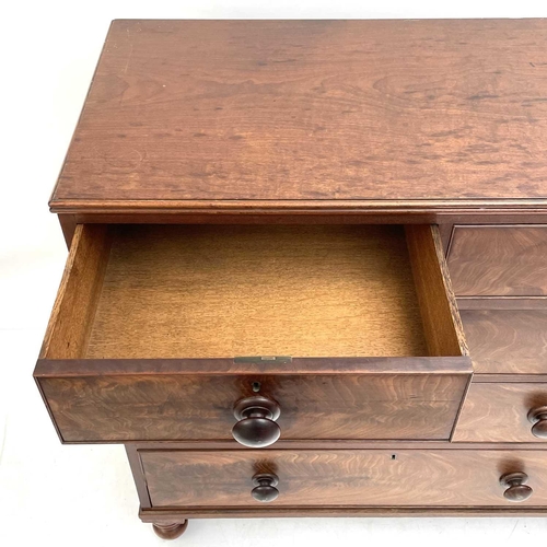 1938 - A 19th century mahogany chest of drawers. With two short and three long drawers on turned bun feet, ... 