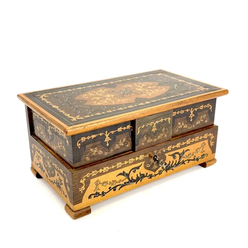 224 - A marquetry box decorated with a naive scene within parquetry borders. Height 11cm width 33.5cm dept... 