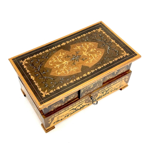 224 - A marquetry box decorated with a naive scene within parquetry borders. Height 11cm width 33.5cm dept... 