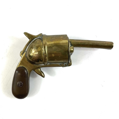 23 - A rare late Victorian brass vesta case modelled as a pistol. Together with a brass miner's snuff box... 