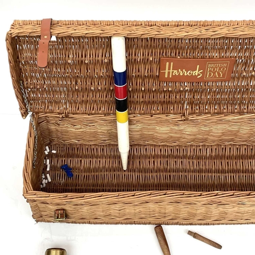 249 - A Harrods Polo Day part croquet set. In a wicker basket.