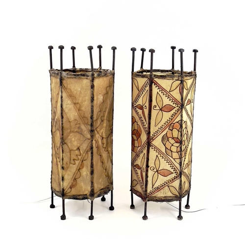 259 - A pair of metal lanterns. The hide shades having tube lined floral decoration. Height 45cm.