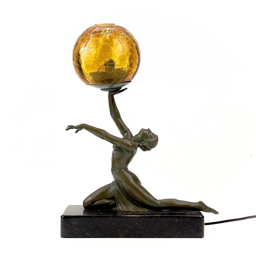 273 - An Art Deco style table lamp. Modelled as a female figure holding an amber glass ball, on a rectangu... 