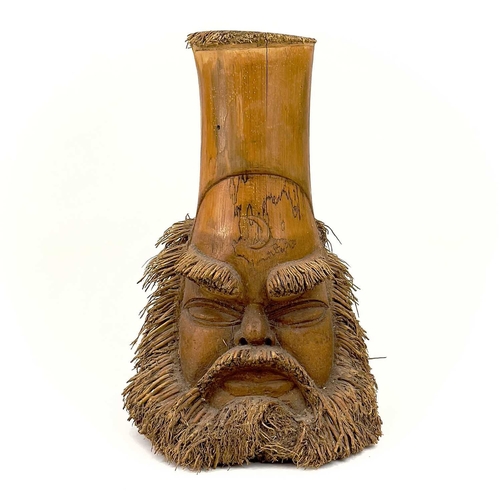 275 - Two oriental carved bamboo root masks of bearded men. Heights 38cm and 35.5cm.