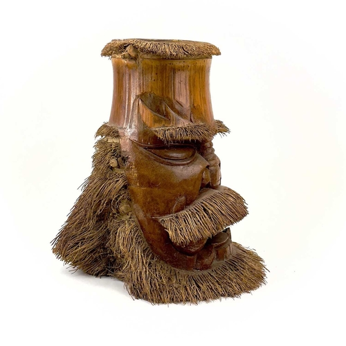 275 - Two oriental carved bamboo root masks of bearded men. Heights 38cm and 35.5cm.