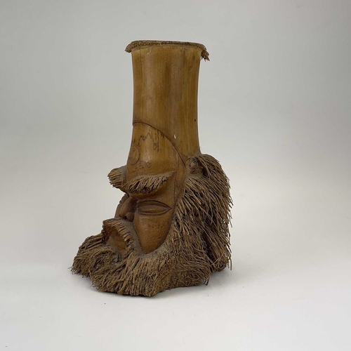 275 - Two oriental carved bamboo root masks of bearded men. Heights 38cm and 35.5cm.