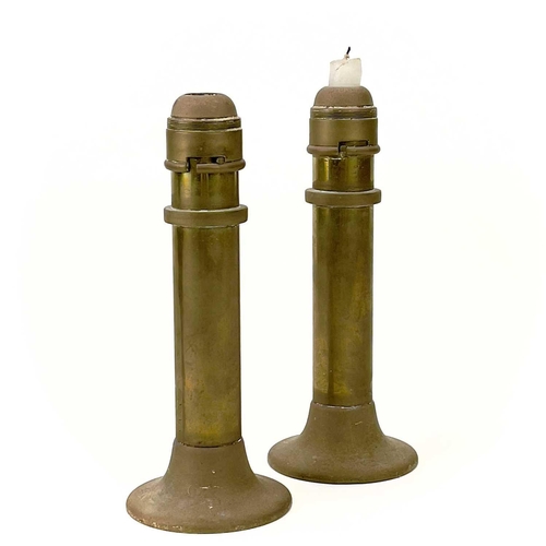 283 - A pair of early 20th century brass spring loaded candle holders. With bayonet mounts, height 22cm to... 