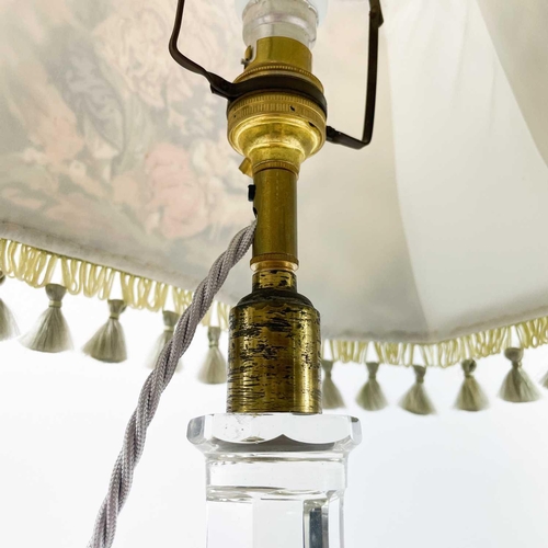 29 - An Edwardian cut glass table lamp. Raised on an octagonal column and stepped star cut square base, h... 