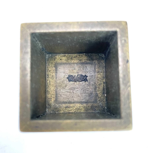 309 - A Chinese brass seal cube. With an inner fitted brass cube and interchangeable seal marks.