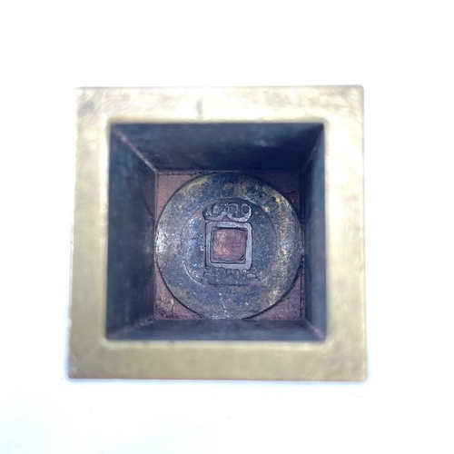 309 - A Chinese brass seal cube. With an inner fitted brass cube and interchangeable seal marks.